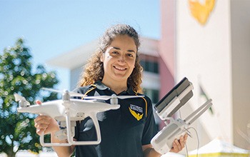 Female USQ lecturer holding drone and remote